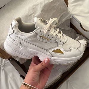Adidas white sneakers with gold detailing